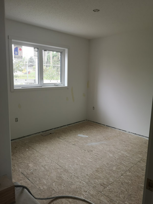 Room with no flooring and one window